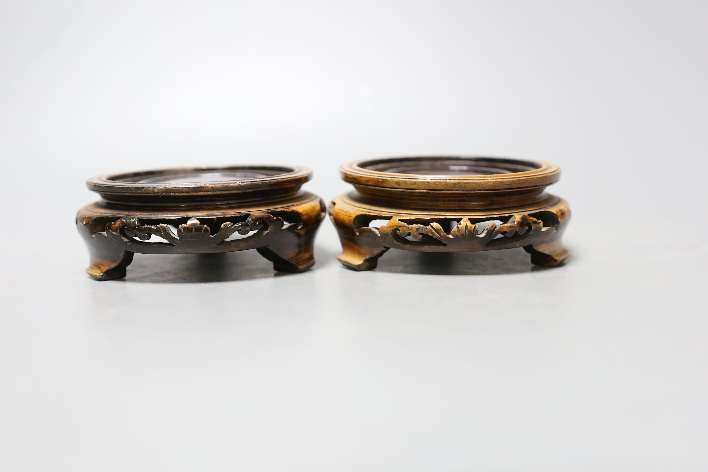 A pair of Chinese cloisonné enamel vases, on carved wood plinths, 30cm